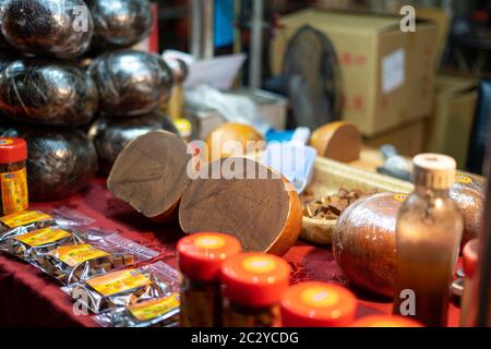 Night market stall selling a traditional chinese medicine called luohan fruit (luo han guo), which is also used to make Licorice Menthol Stock Photo