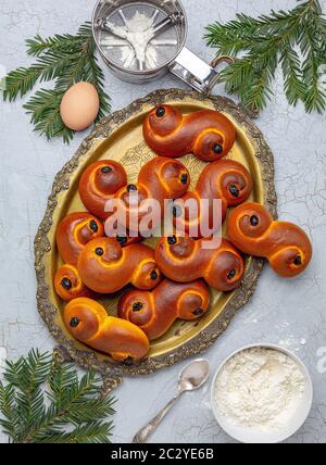 Swedish saffron buns (Lussekatt) on a metal tray. Stock Photo