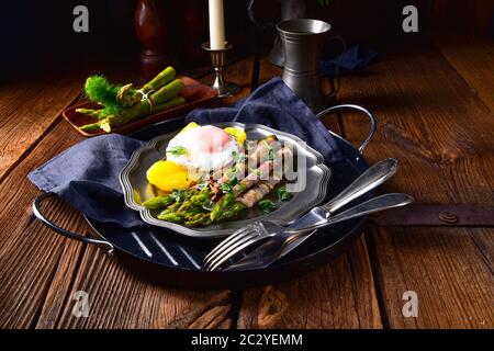 delicious green asparagus wrapped in bacon and egg Stock Photo