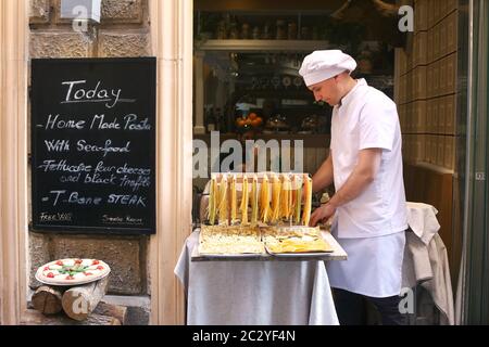 A chef prepares fresh pasta in the street for a resturant in Rome, Italy. Stock Photo