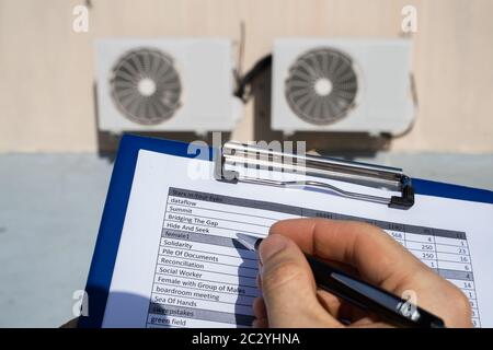 Man Doing Heating, Ventilation, And Air Conditioning Inspection Stock Photo