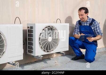 Man Doing Heating, Ventilation, And Air Conditioning Inspection Stock Photo