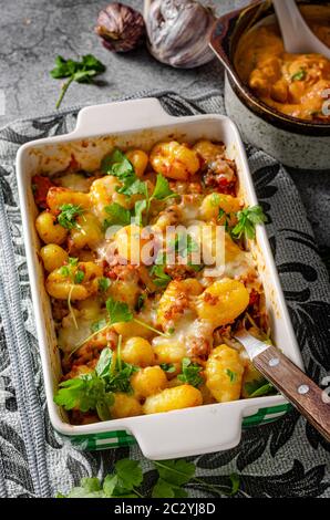 Super fast and delicious food, gratinated gnocchi with minced meat, tomatoes and cheese Stock Photo