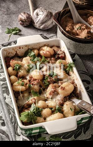 Super fast and delicious food, gratinated gnocchi with minced meat, tomatoes and cheese Stock Photo