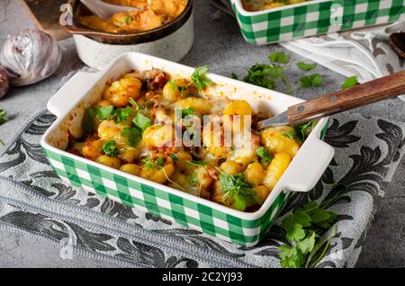 Super fast and delicious food, gratinated gnocchi with minced meat, tomatoes and cheese Stock Photo