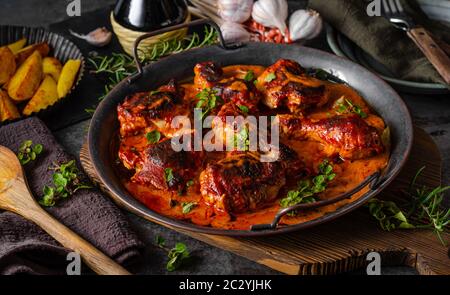 Original tikka chicken with hot sauce and butter, fresh garlic and herbs Stock Photo