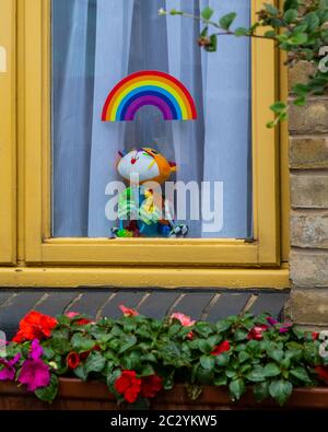 London, UK - June 17th 2020: Rainbow sticker and cuddly toy in the window of a house in London, UK.  During the Coronavirus pandemic, the rainbow has
