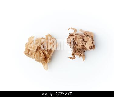 two crumpled sheets of brown paper on a white background, close up, top view Stock Photo