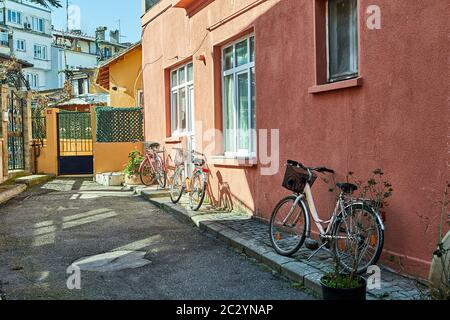 Istanbul, Turkey - February 13, 2020: Istanbul, Turkey - February 13, 2020: The facade of a residential building with three parked bicycles on the isl Stock Photo