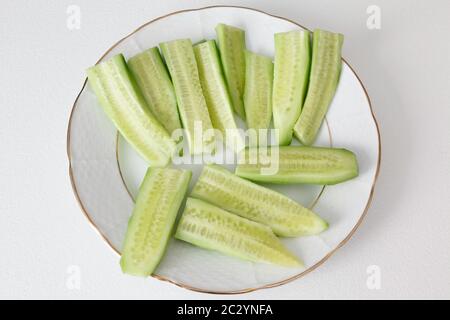 Sliced cucumber on white plate. Stock Photo
