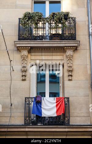 French flag hanging on a balcony in Montmartre district, Paris, France, Europe. Stock Photo