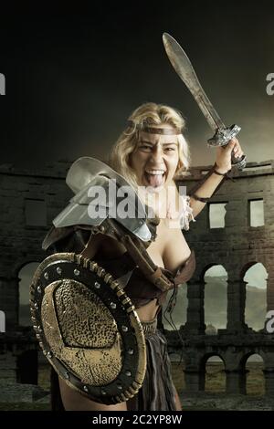 Ancient woman warrior or Gladiator posing outdoors with sword and ...