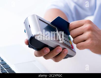 Man processing credit card transaction with POS terminal Stock Photo