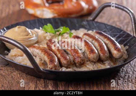 grilled nuremberger bratwurst with sauerkraut Stock Photo