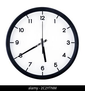 Classic analog clock pointing at five forty, isolated on white background. Stock Photo