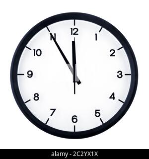 Classic analog clock pointing at eleven fifty five, isolated on white background. Stock Photo