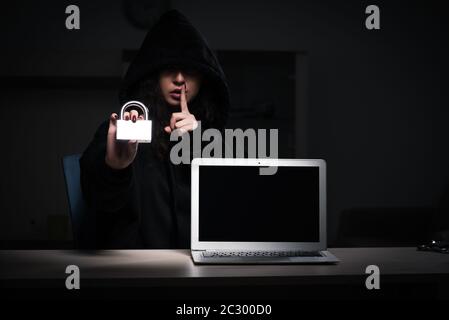 Female hacker hacking security firewall late in office Stock Photo