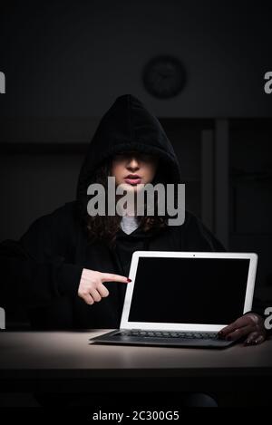 Female hacker hacking security firewall late in office Stock Photo