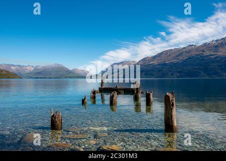 Decayed jetty, old wooden posts in Lake Wakatipu, near Glenorchy, Otago, South Island, New Zealand Stock Photo