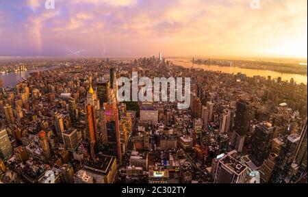 New York City skyline with Manhattan skyscrapers at dramatic vibrant after the storm sunset, USA. Rainbow can be seen in background over Brooklyn brid Stock Photo