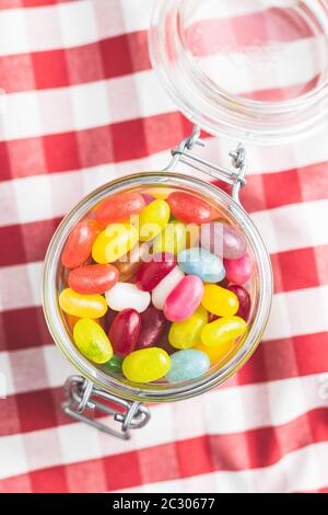 Fruity jellybeans. Tasty colorful jelly beans in glass jar. Stock Photo