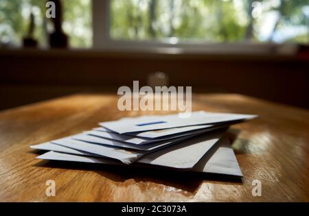 Envelopes on the wooden table during sunny day Stock Photo