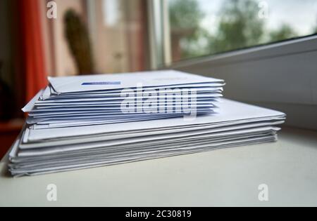 Stack of envelopes near the window Stock Photo