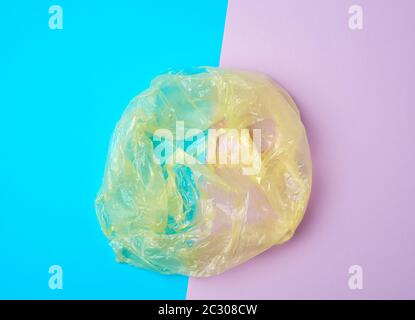 open empty plastic bag for products on a colored background, concept of rejection of plastic bags to save the environment Stock Photo