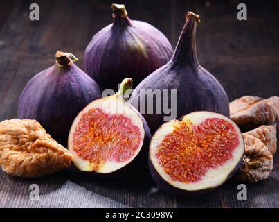 Composition with fresh and dried figs on wooden table. Stock Photo