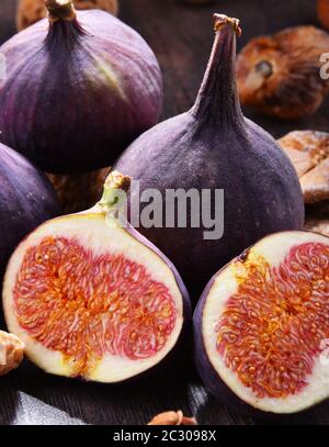 Composition with fresh and dried figs on wooden table Stock Photo - Alamy