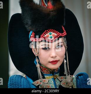 Young Mongolian lady is posing in traditional costume, portrait, Ulaanbaatar capital city, Mongolia Stock Photo