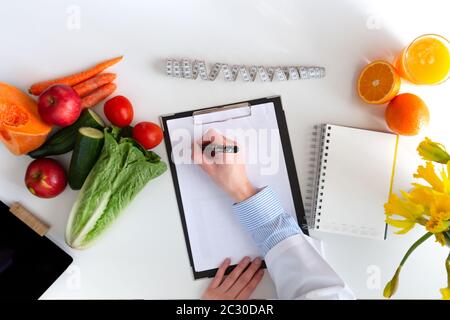 Vegetable diet nutrition and medication concept. Nutritionist offers healthy vegetables diet. In a natural light Stock Photo