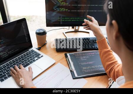 Asian team Outsource Developer Looking Screen Programming Code Working with Laptop Computer Software Stock Photo