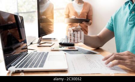 Pensive programmer working on on desktop pc programming code technologies or website design at office Software Development Company. Stock Photo