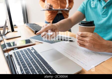 Pensive programmer working on on desktop pc programming code technologies or website design at office Software Development Company. Stock Photo