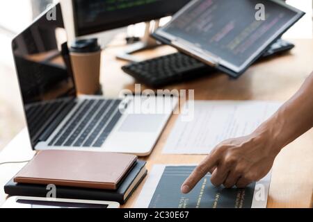 Asian team Outsource Developer Looking Screen Programming Code Working with Laptop Computer Software Stock Photo