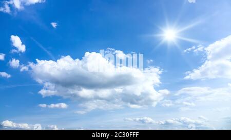 typical beautiful blue sky sun clouds background Stock Photo