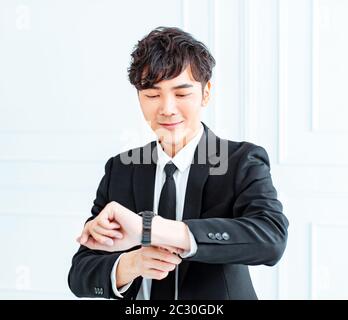 Business man looking at watch in office Stock Photo