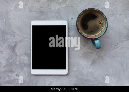 Cup of black coffee and tablet on gray background Stock Photo