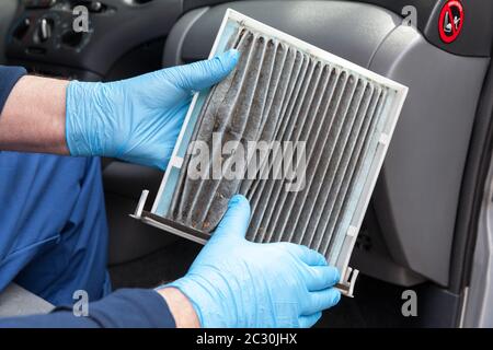 Replacing an old car cabin pollen filter Stock Photo - Alamy