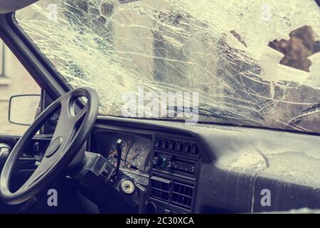 Broken car windshield smashed by a thief. Damaged glass from car theft Stock Photo
