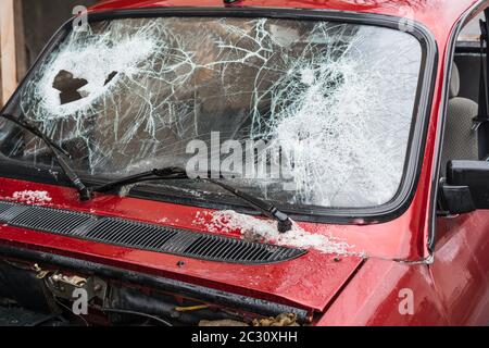 Broken car windshield smashed by a thief. Damaged glass from car theft Stock Photo