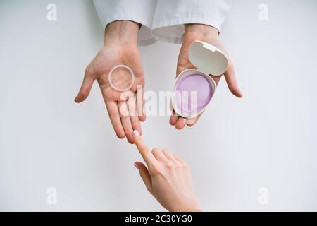 Gynecologist Showing Contraception Ring And Diaphragm To Woman And Explaining Contraception And Birth Control Stock Photo