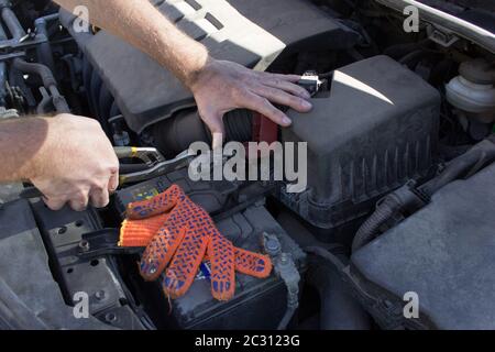 Mechanic at work, Close up detail of car engine under the open hood. Stock Photo