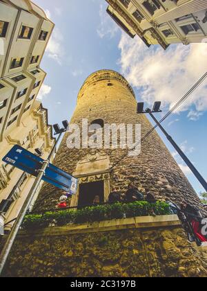 Galata Tower and the street in the Old Town of Istanbul, Turkey October 27, 2019. BELTUR Galata Kulesi or Galata tower in the ol Stock Photo