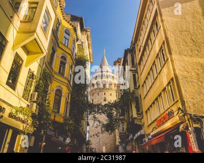 Galata Tower and the street in the Old Town of Istanbul, Turkey October 27, 2019. BELTUR Galata Kulesi or Galata tower in the ol Stock Photo