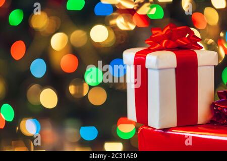 gift boxes with ribbon and bow on holiday lights background Stock Photo