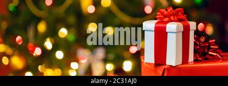 gift boxes with ribbon and bow on holiday lights background Stock Photo