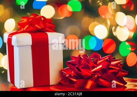 gift boxes with ribbon and bow on holiday lights background Stock Photo