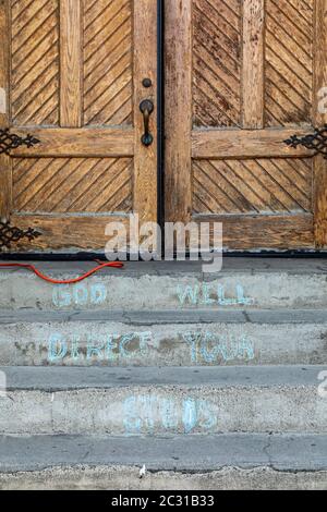 Detroit, Michigan - A message chalked on the steps of Ste. Anne de Detroit Catholic Church. Founded in 1701 by French colonists, the parish is now mos Stock Photo